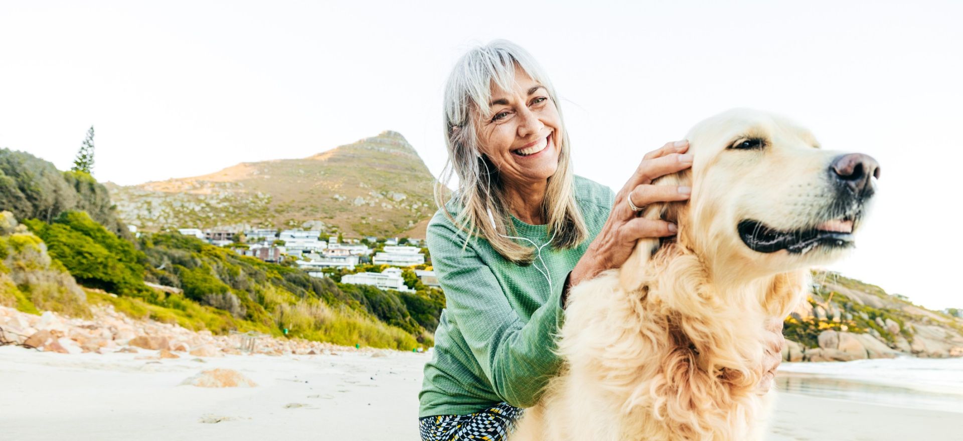 A woman typing on a laptop in a bright, modern home office setting.