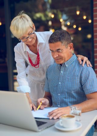 Elegant senior woman enjoying her smartphone experience indoors wearing eyeglasses.